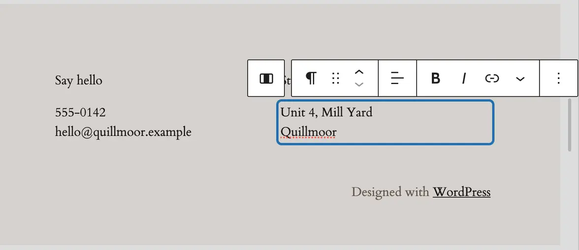 The footer open in the editor, the studio address outlined and selected, ready to retype