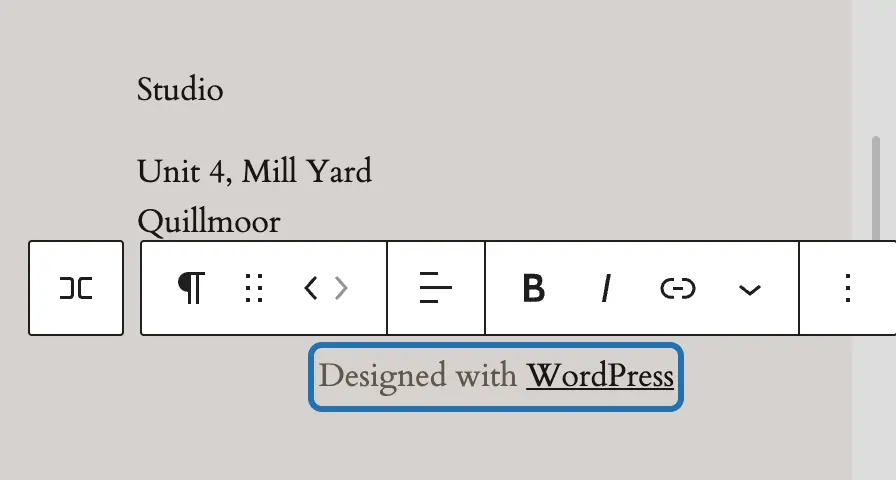 The footer open in the Site Editor, the Designed with WordPress line selected and outlined, its toolbar above it